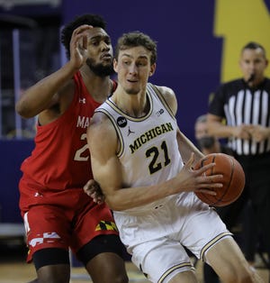 Michigan Wolverines Franz Wagoner (21) leads Maryland Terrapins striker Donta Scott (24) during the first half on Tuesday 19 January 2021 in Ann Arbor.