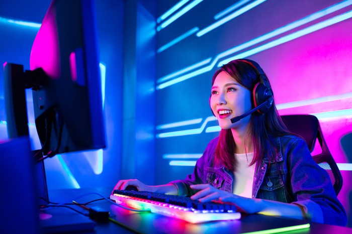 A woman uses a computer to play games.